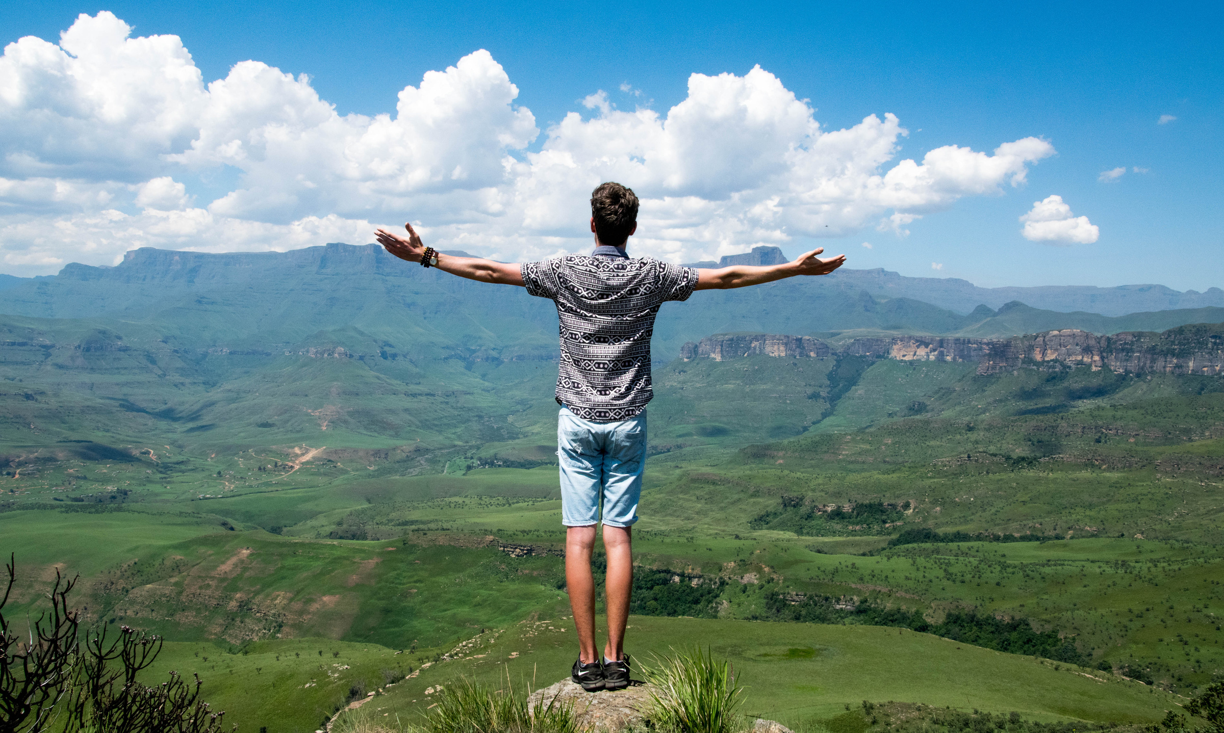 Man Wearing Grey Shirt Standing on Elevated Surface